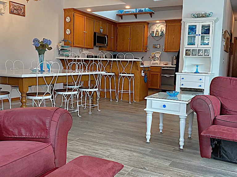 Comfortable Porcelain Plank Tile Floors flow from the Living Room into the Kitchen