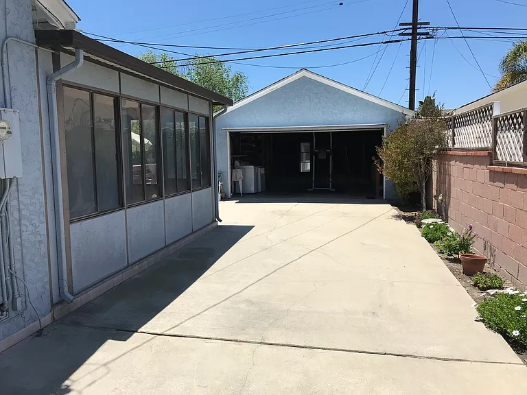 Driveway behind gate provides parking for extra cars or RV. Two-car garage has storage, workbench, and newer gas dryer and washing machine. "Mud room" adjacent to family room provides extra space or storage.