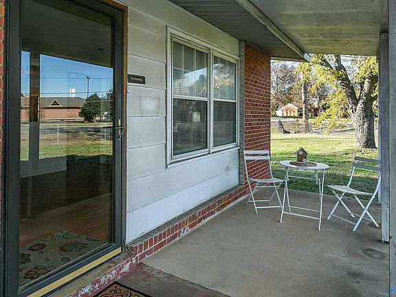 Another view of the front porch showing the front door & living room window. Bistro set shown is no longer available
