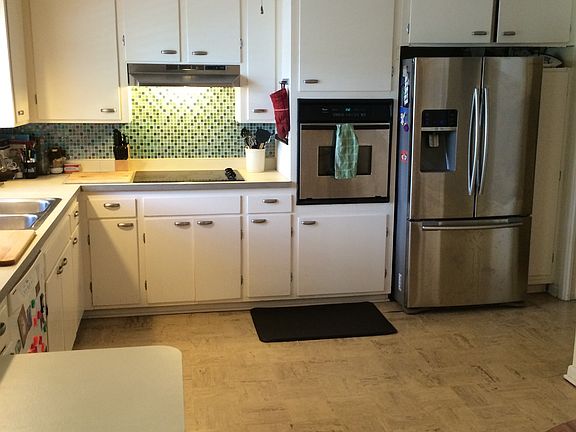 Original cabinet, formica countertops, glass tile backsplash