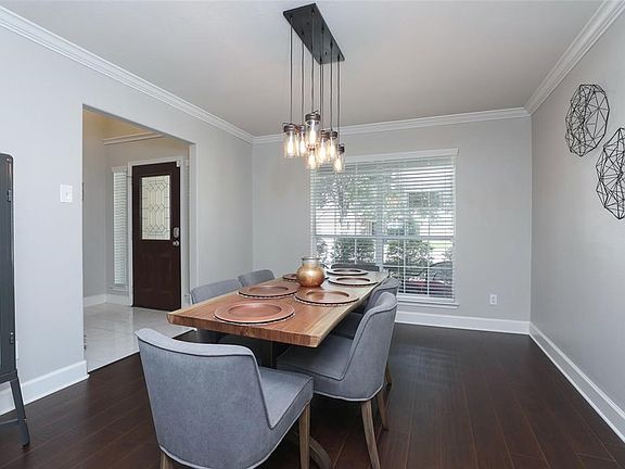 Dining Room with crown molding and 2" baseboards.