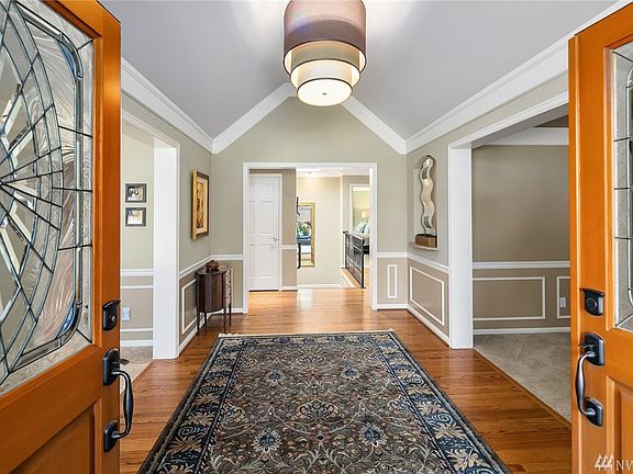 Come inside. The living room is on the right, dining room on the left, and the stairs to the lower level are straight ahead, under a large skylight.