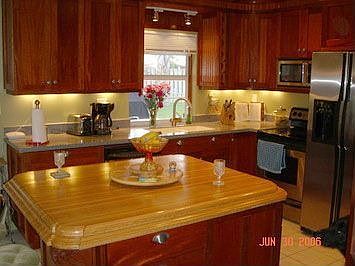 custom mahogany kitchen with window pass-through to patio