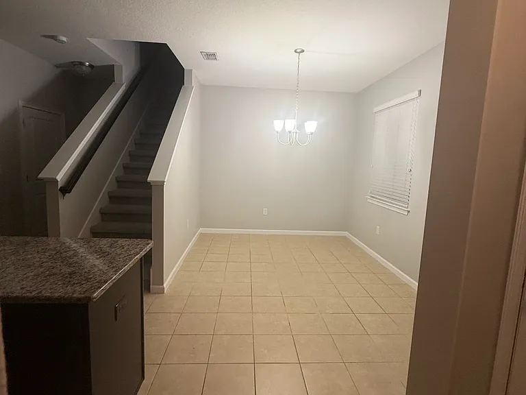 Open-concept dining area adjacent to the kitchen with ample space for formal dining or a flexible living area.