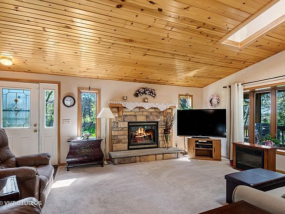 Open concept living with skylights anda knotty pine beadboard vaulted ceiling!