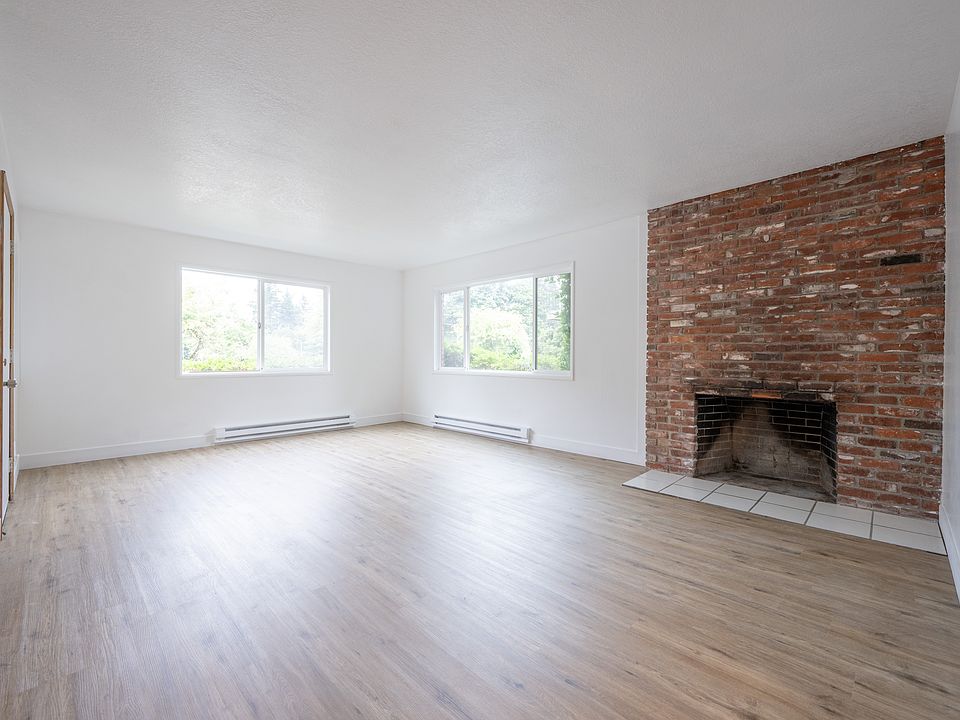 Extended Living Room With Beautiful Bricked Fireplace, view of the golf course out the front windows