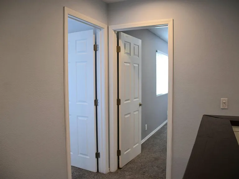 top of stairs looking into bedroom one on left and bedroom two straight ahead