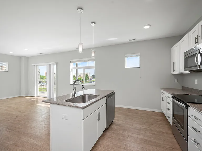 Modern kitchen with sleek appliances, spacious countertops, and ample natural light, perfect for entertaining. Modern kitchen with sleek appliances, spacious countertops, and ample natural light, perfect for entertaining.