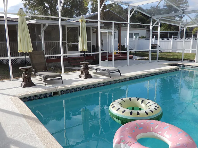 Interior View of screened porch and gazebo as seen from southeast end of pool deck area.