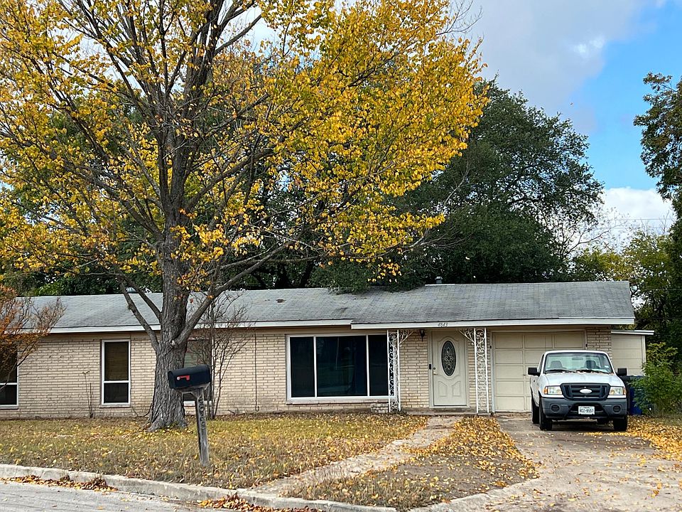 Large front yard and long driveway, single car garage with in-unit laundry.