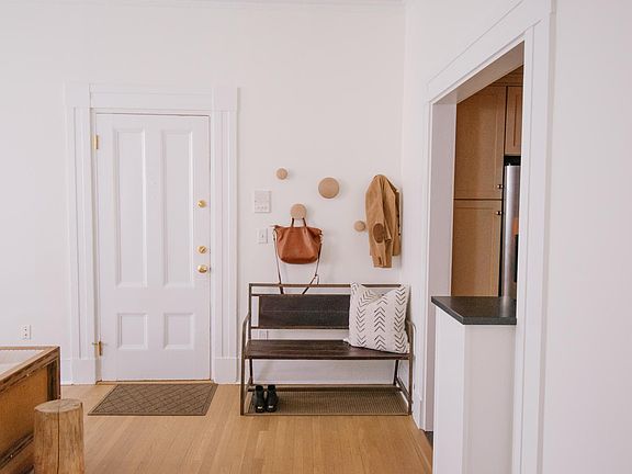 Entryway with hooks & waterhog mat for shoes.