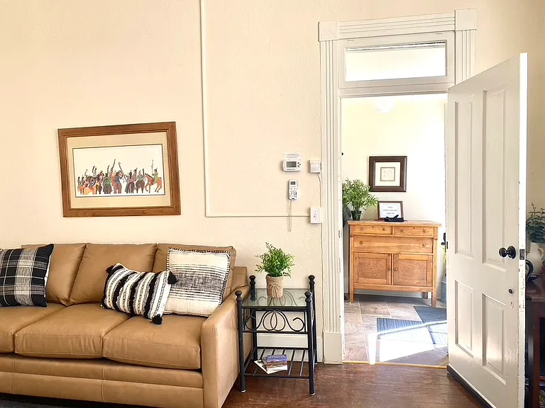 New Bassett leather sofa in large living room, sun lit entry.