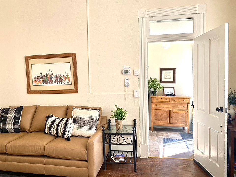 New Bassett leather sofa in large living room, sun lit entry.