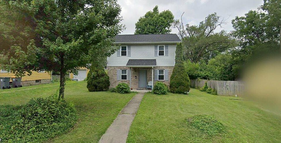 Exterior of house with lots of lawn and greenspace