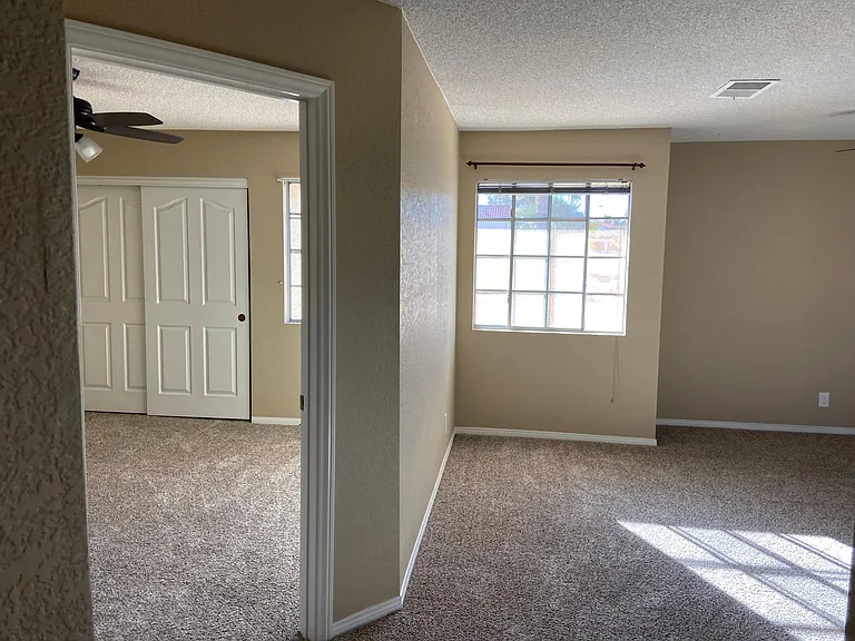 Upstairs a bedroom (left) and the large bonus room(right)