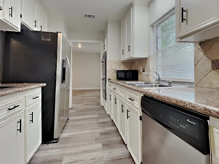 Spacious kitchen with white ca