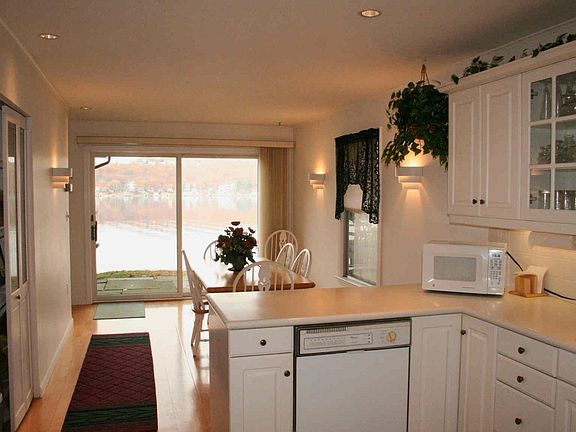 Sliders from this modern kitchen open to the patio and deck.