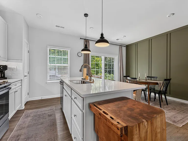 Kitchen/Dining Area with accent wall and upgraded light fixtures