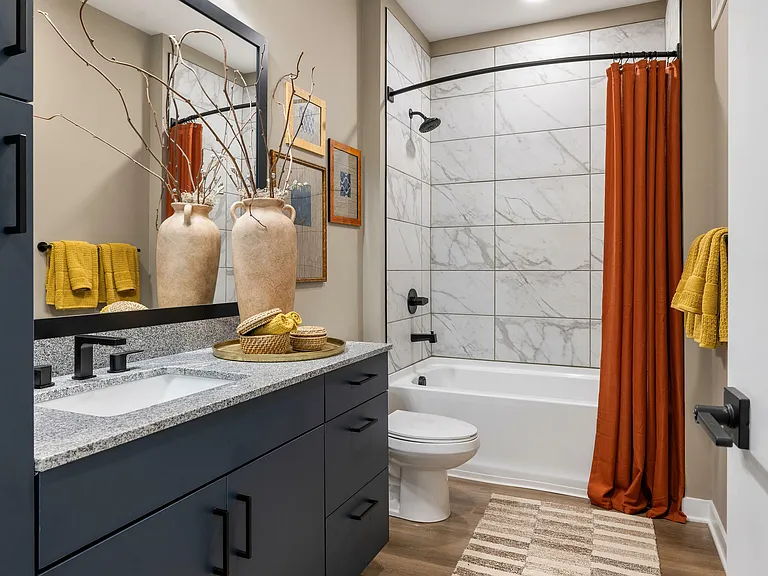Luxe bathrooms with quartz counter tops and ample storage