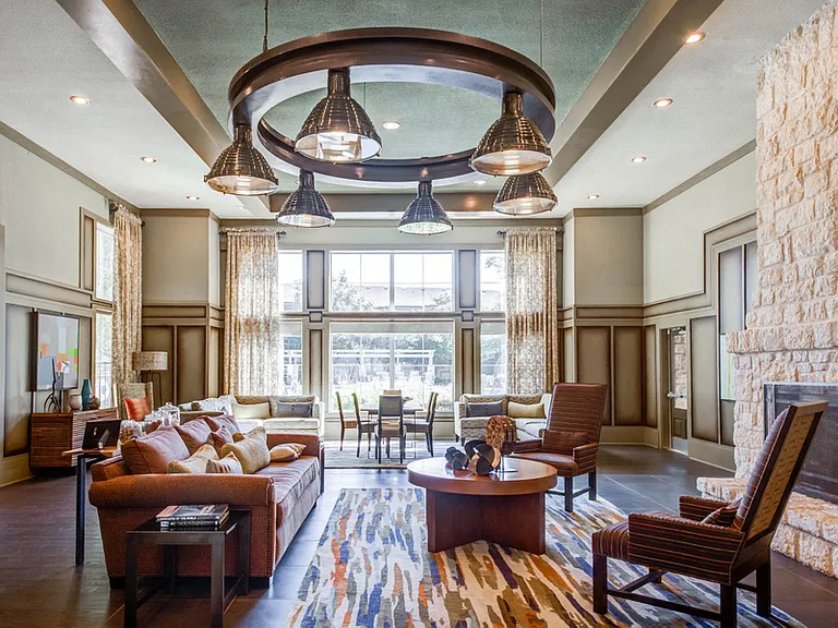 Community lounge with couch seating and a fireplace