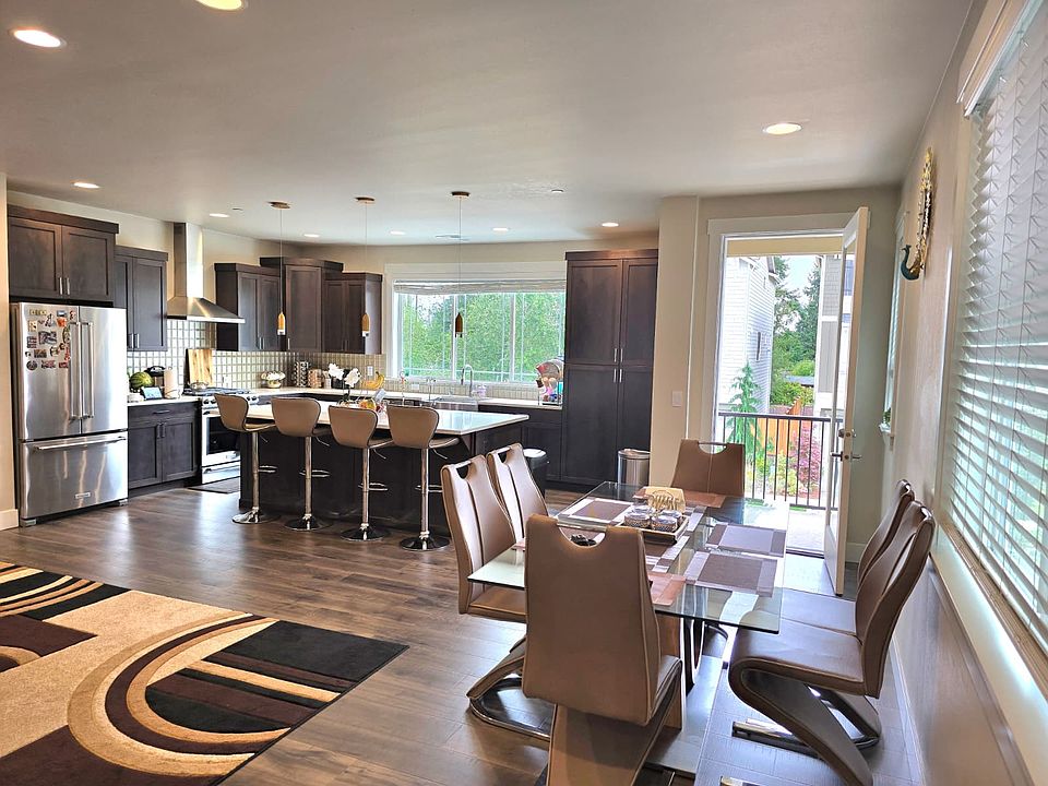 Spacious Kitchen with kids park view through the window, and balcony/patio facing towards the road