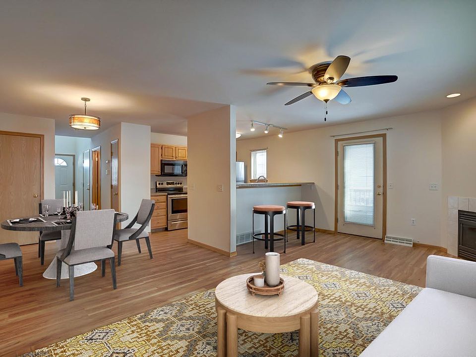 Main floor living room, dining area, and kitchen. Eat-at kitchen bar, gas fireplace, and walk-out to private 10x10 deck. Virtually staged
