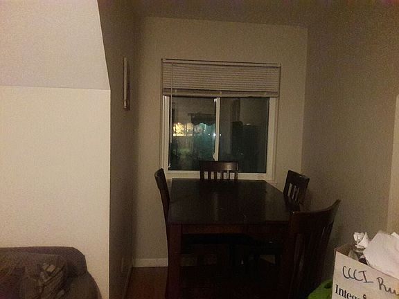 Dinner table area near front window and same space a living