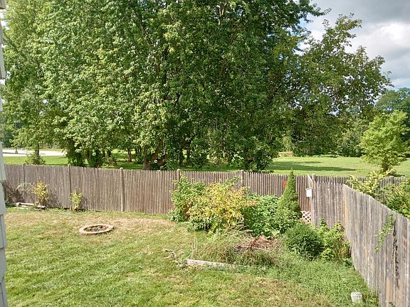 Fenced in back yard, overlooks field. Community trail in the background.