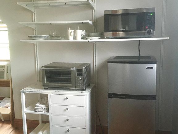 The mini kitchen will have an assortment appliances and kitchenware. There's a sink and kitchen table too.