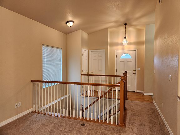 Entry Way at Front Door, Powder Room Door next to Front Door, Door to the Left is a Coat Closet