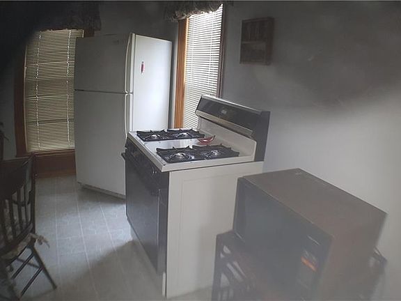 The "rest" of the kitchen.Table and chair to the left for use as an "eat in kitchen.