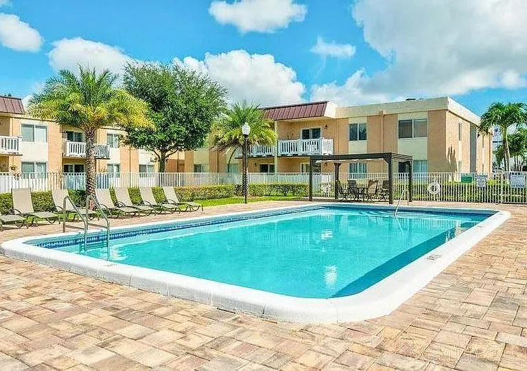 FRONT POOL WITH CABANA AND LOUNGE CHAIRS