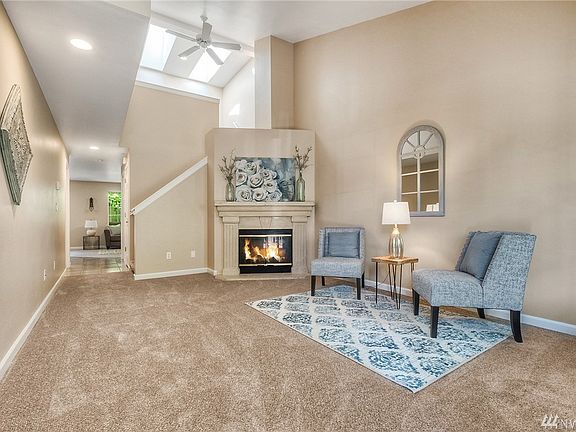 Looking from the front door in you can see how large the room is and the skylights bring in great natural light. The new buyer will enjoy all new carpet, paint, doors & millwork throughout the home! 