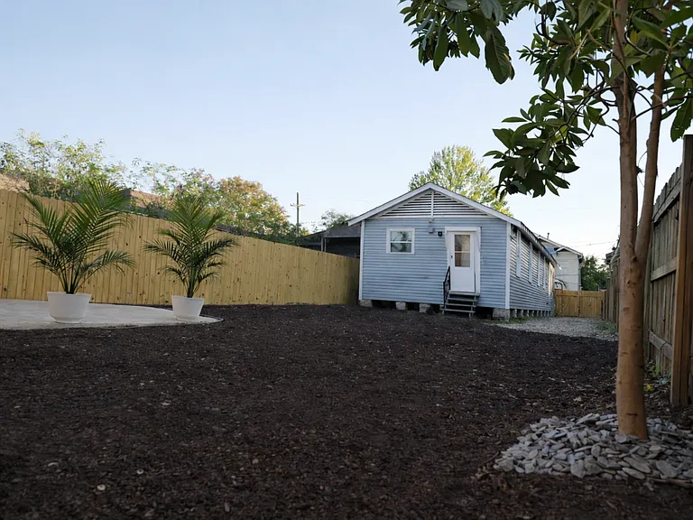 Spacious private backyard with new fencing, designated entertaining area, and freshly planted grass