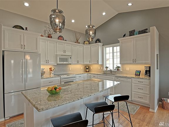 Remodeled kitchen with custom cabinets, granite counters and glass tile backsplash.