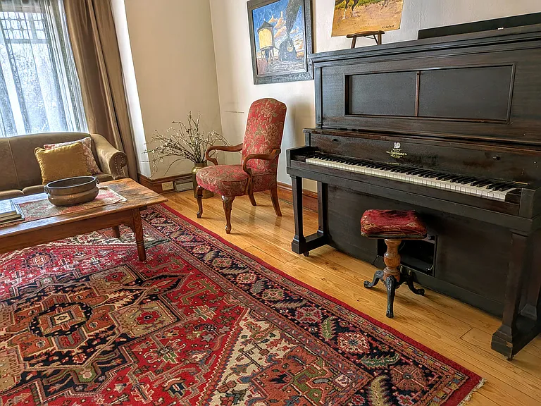 Spacious Living Room with sofa bed and piano.