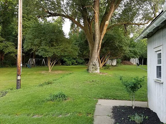 Side of house next to parking area and yard