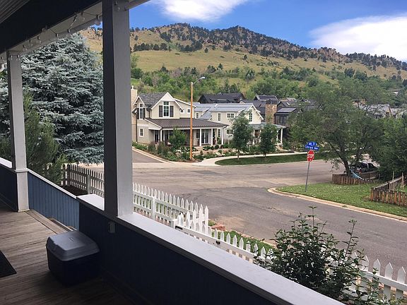 Epic Mt. Sanitas and Dakota Ridge view from porch. Quick access to trail through visible new build neighborhood.
