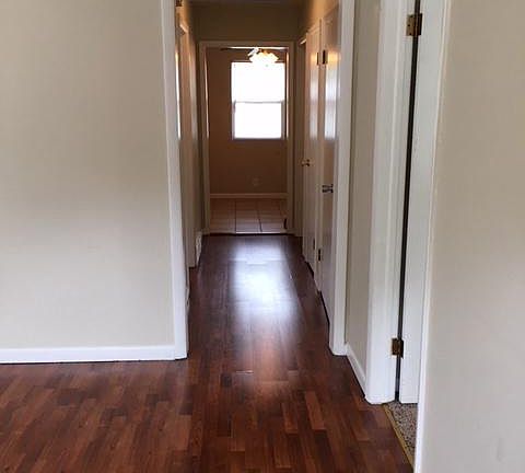 Living room with hallway to bedrooms, bath, and eat-in kitch