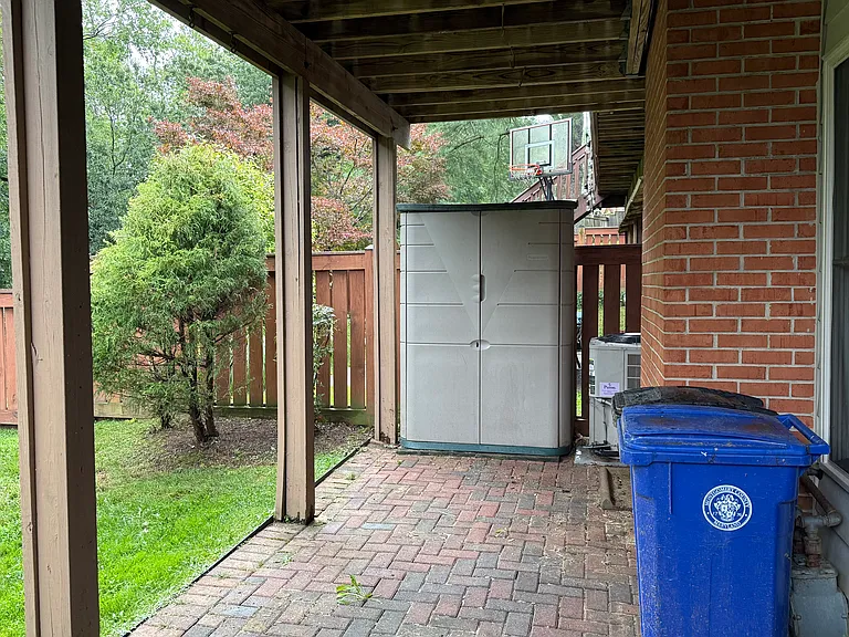 Private lower brick patio overlooking the woods