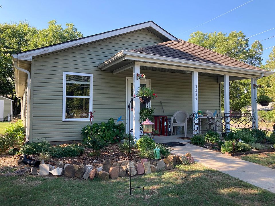 Nice front porch and flower garden.