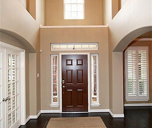 As you enter into the foyer, take note of the high ceilings, large art niches and beautiful hardwood