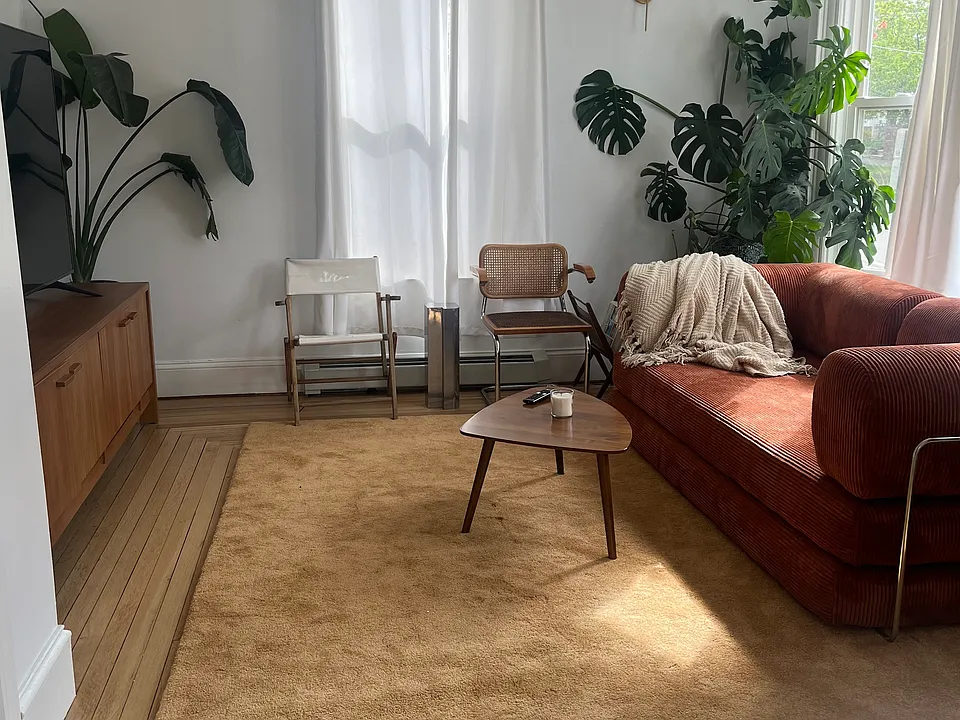 Bedroom #2, set up as living room. Giant windows and restored 1910 hardwood floors.
