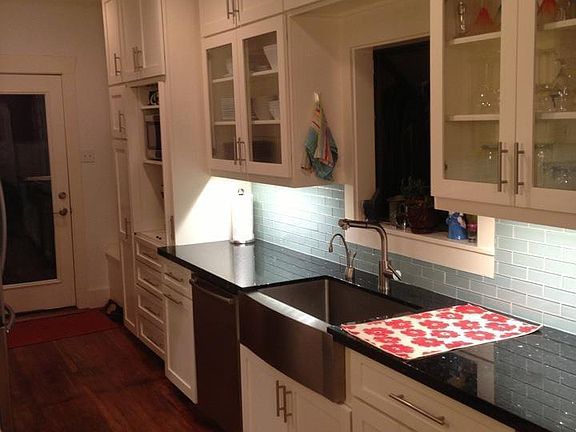 Lots of kitchen cabinets, bay window over the sink