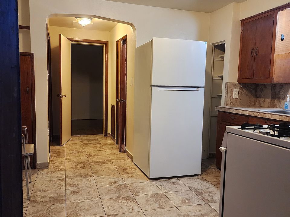 View into kitchen and hallway, bedroom beyond from front door.