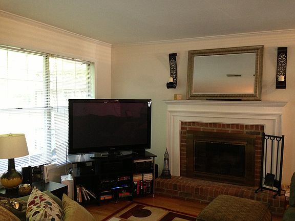 The living room gets great natural light through large windo