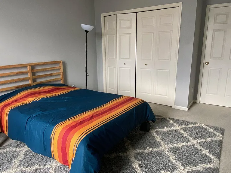 Large bedroom with ample closets and large window.