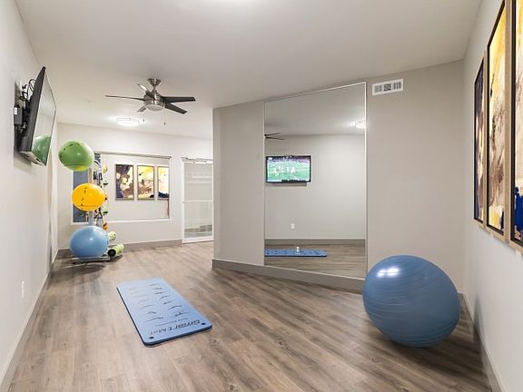 Resident fitness center with free weights and cardio equipment