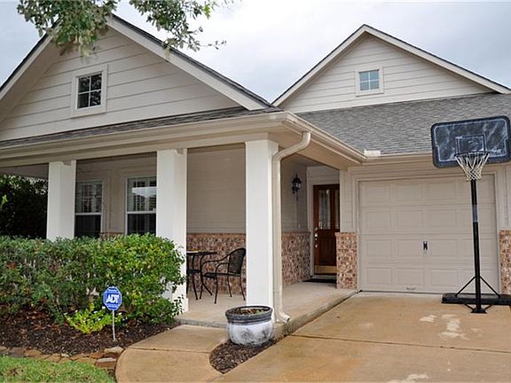 Walks up to Green Brush showing Porch and Nice Wooden Door.