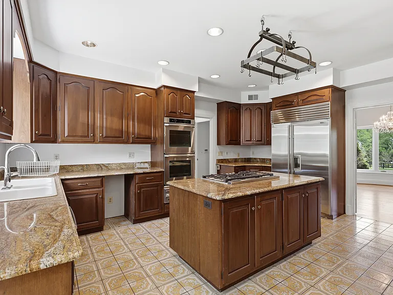 Spacious kitchen, granite island and cabinetry.